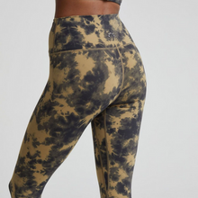 Load image into Gallery viewer, Female model wearing flaxen tie dye colored Let's Go High Rise leggings from Varley