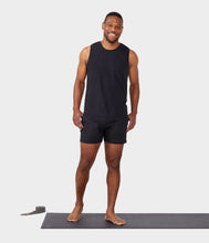 Load image into Gallery viewer, black male model standing on yoga mat wearing black tank and black athletic shorts