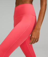 Load image into Gallery viewer, female model wearing pale raspberry colored leggings from lululemon