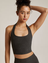 Load image into Gallery viewer, Woman wearing Beyond Yoga Darkest Night halter top and darkest night yoga leggings.
