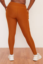 Load image into Gallery viewer, Female model wearing orange pocket legging from wolven