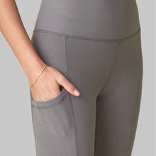 Load image into Gallery viewer, Female model wearing gray pocket legging from wolven