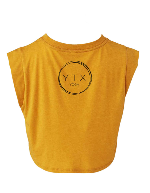 Back of a mustard colored tank with black YTX Yoga logo.
