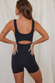 Back of woman wearing black shorts onesie