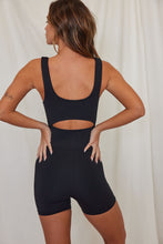 Load image into Gallery viewer, Back of woman wearing black shorts onesie