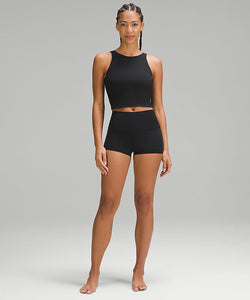 Woman wearing a black sports bra and black shorts