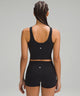 Back of a woman wearing a black sports bra and black shorts from lululemon