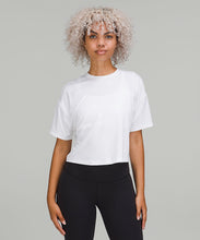Load image into Gallery viewer, Woman wearing white t-shirt and black pants from lululemon