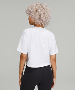 Back of a woman wearing a white t-shirt and black shorts from lululemon