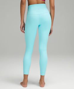 Back oBack view of a woman wearing lululemon yoga leggings in cyan blue