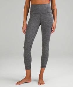 Legs of a woman wearing grey yoga leggings from lululemon