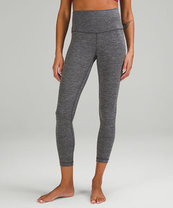 Image of a woman's legs, wearing grey lululemon leggings