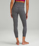Back of a woman's legs, wearing grey yoga leggings from lululemon