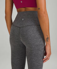 Load image into Gallery viewer, Close up of the back of a woman wearing a pink top and grey yoga leggings from lululemon