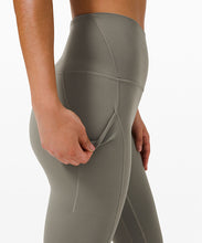 Load image into Gallery viewer, close up of a woman opening the pocket of a pair of yoga leggings