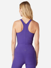 Load image into Gallery viewer, Back of a Woman wearing a violet tank top and violet leggings pants