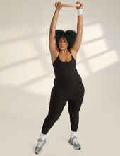 Load image into Gallery viewer, Model wearing black athletic jumpsuit with adjustable straps