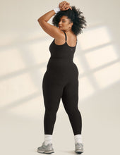Load image into Gallery viewer, Model wearing black athletic jumpsuit with adjustable straps