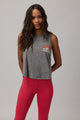 Woman wearing a grey tank top that reads "spiritual gangster" and red pants