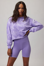 Load image into Gallery viewer, Woman wearing a purple and white tie dye sweater with purple shorts