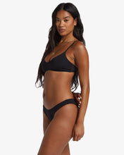 Load image into Gallery viewer, Woman wearing a black bikini from Billabong. 