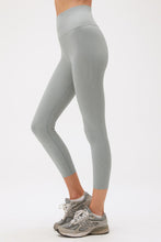 Load image into Gallery viewer, side of woman in stormy blue yoga leggings with grey sneakers