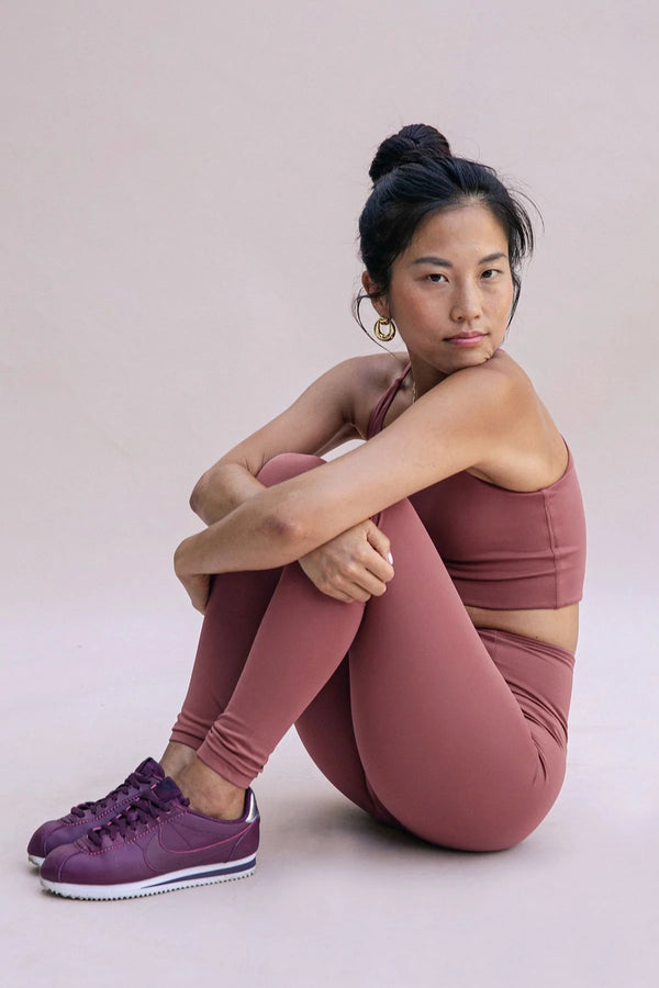 Female model wearing Fig colored leggings from Girlfriend Collective