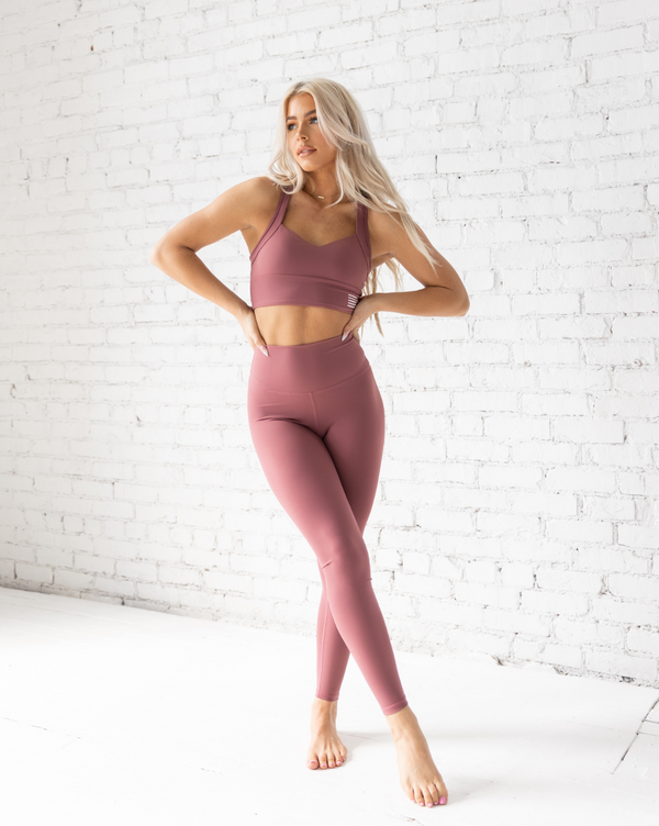 Female model wearing clay leggings from kosha fit