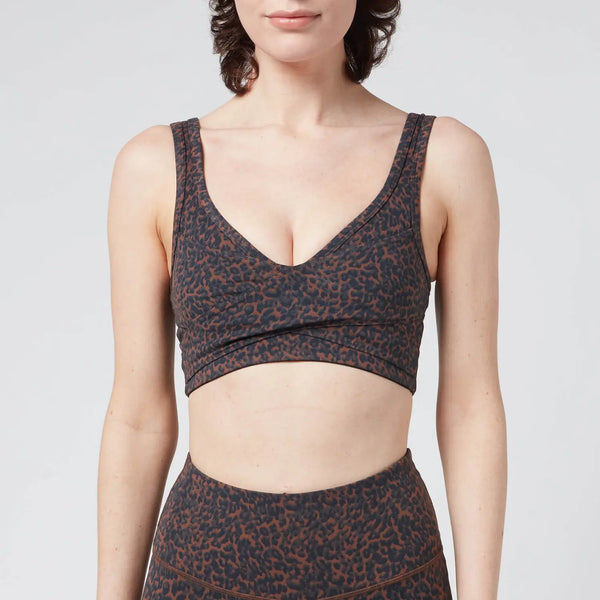 Female model wearing "Let's Move Kellam"  Bronze Distorted Cheetahprint sports bra from Varley 