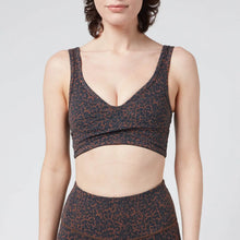 Load image into Gallery viewer, Female model wearing &quot;Let&#39;s Move Kellam&quot;  Bronze Distorted Cheetahprint sports bra from Varley 