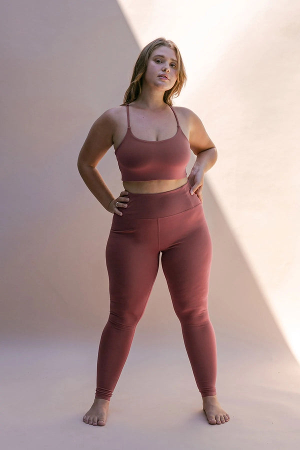 Female model wearing Fig colored leggings from Girlfriend Collective