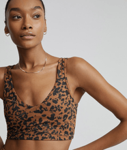 Load image into Gallery viewer, Female model wearing &quot;Let&#39;s Move Kellam&quot; RUST DISTORTED ANIMAL print sports bra from Varley 