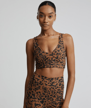 Load image into Gallery viewer, Female model wearing &quot;Let&#39;s Move Kellam&quot; RUST DISTORTED ANIMAL print sports bra from Varley 