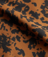 Load image into Gallery viewer, fabric details of &quot;Let&#39;s Move Kellam&quot; RUST DISTORTED ANIMAL print sports bra from Varley 