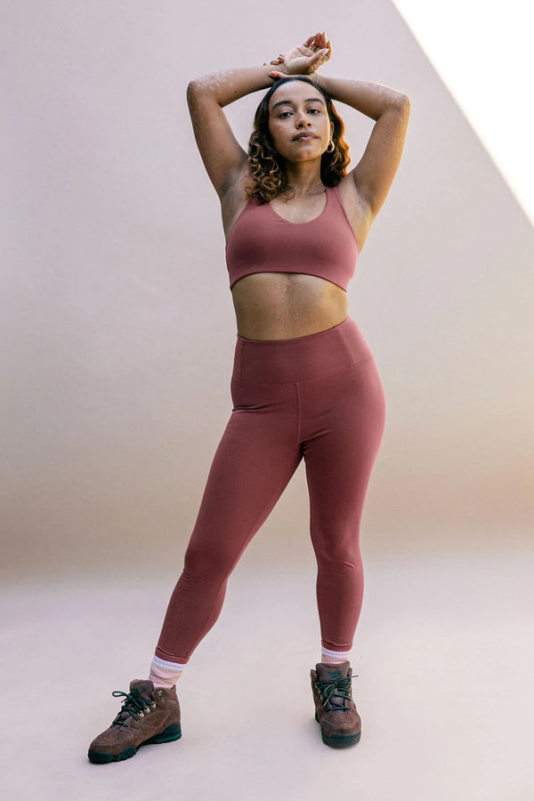 Female model wearing Fig colored leggings from Girlfriend Collective