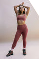 Female model wearing Fig colored leggings from Girlfriend Collective