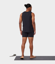 Load image into Gallery viewer, black male model standing on yoga mat wearing black tank and black athletic shorts