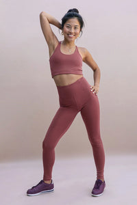Female model wearing Fig colored leggings from Girlfriend Collective