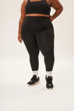 Load image into Gallery viewer, Female model wearing black leggings from Girlfriend Collective