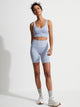 Female model wearing Zen blue Always Edwards Bra from Varley