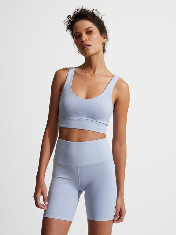 Female model wearing Zen blue Always Edwards Bra from Varley