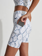 Load image into Gallery viewer, Female model wearing Let&#39;s Go Pocket short in white snake print from Varley