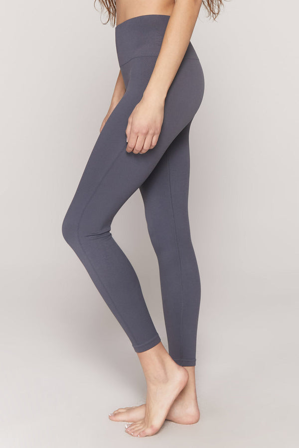 Female model wearing slate gray leggings from spiritual gangster