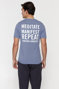 male model wearing "meditate, manifest, repeat" washed blue t-shirt from spiritual gangster 