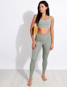Female model wearing agave colored leggings from Girlfriend Collective