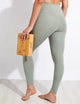 Female model wearing agave colored leggings from Girlfriend Collective