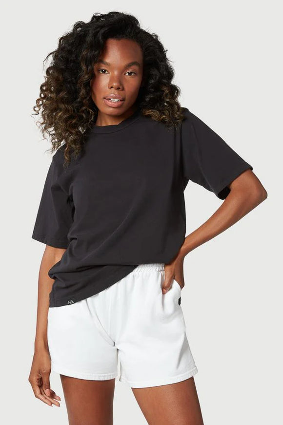 Female model wearing black loose t-shirt from Nux Active clothing