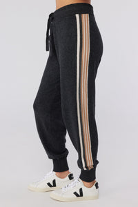 A young female model wearing gray striped Knit Joggers from Spiritual Gangster