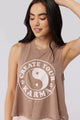 Female model wearing mauve colored tank that reads "Create Your Karma" with yin yang symbol