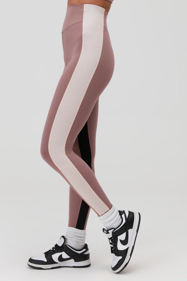 Female model wearing mauve colored leggings 